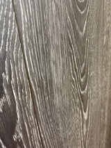 Close-up of Kronotex 4798 laminate showing dark grey oak-look grain with pale highlights and a plank seam