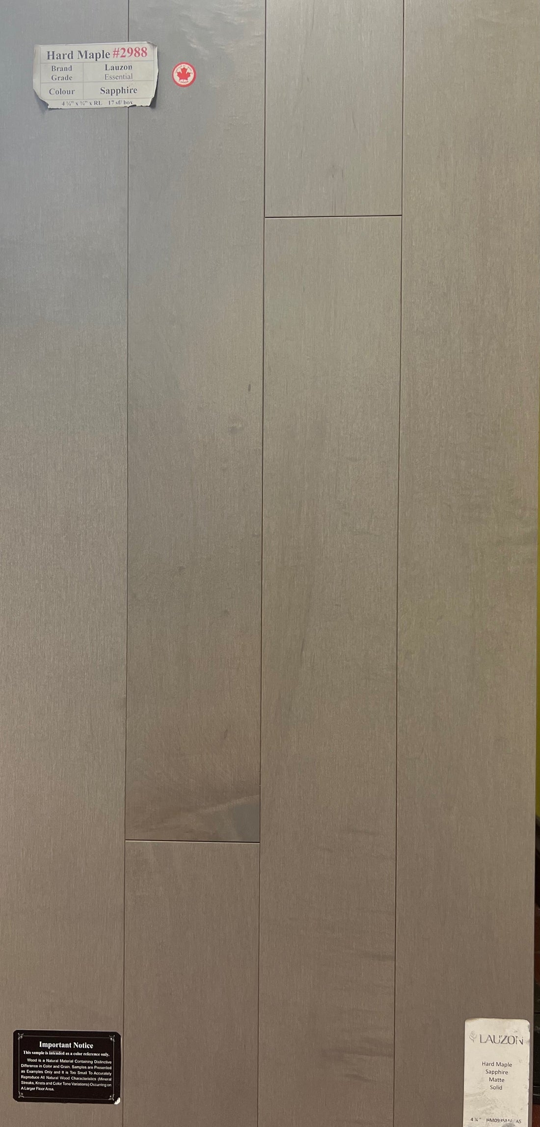 Sample board of Lauzon Essential Hard Maple Sapphir solid hardwood in a grey tone with the manufacturer's sample label on it