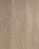 Close-up of Driftwood Mist SPC vinyl planks in a pale light-oak wood grain